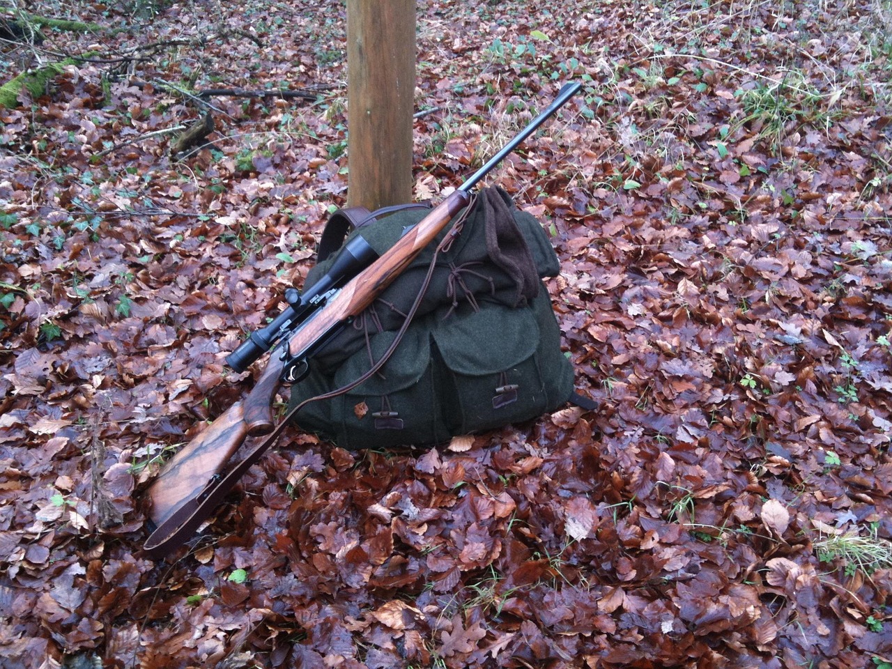Tree stand hunter muffling a cough with a foam cough silencer in cold weather.